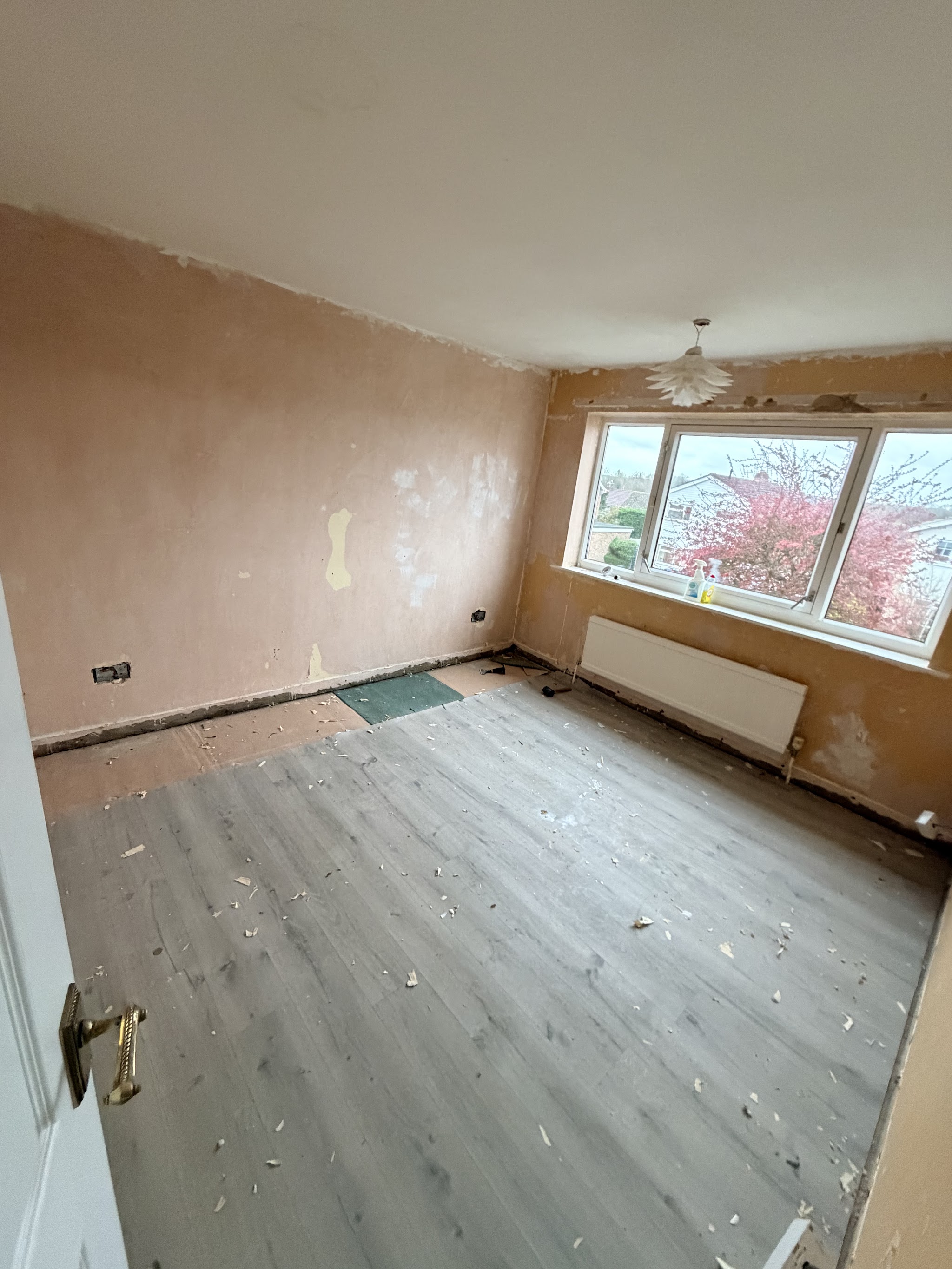 Freshly plastered bedroom with a large window
