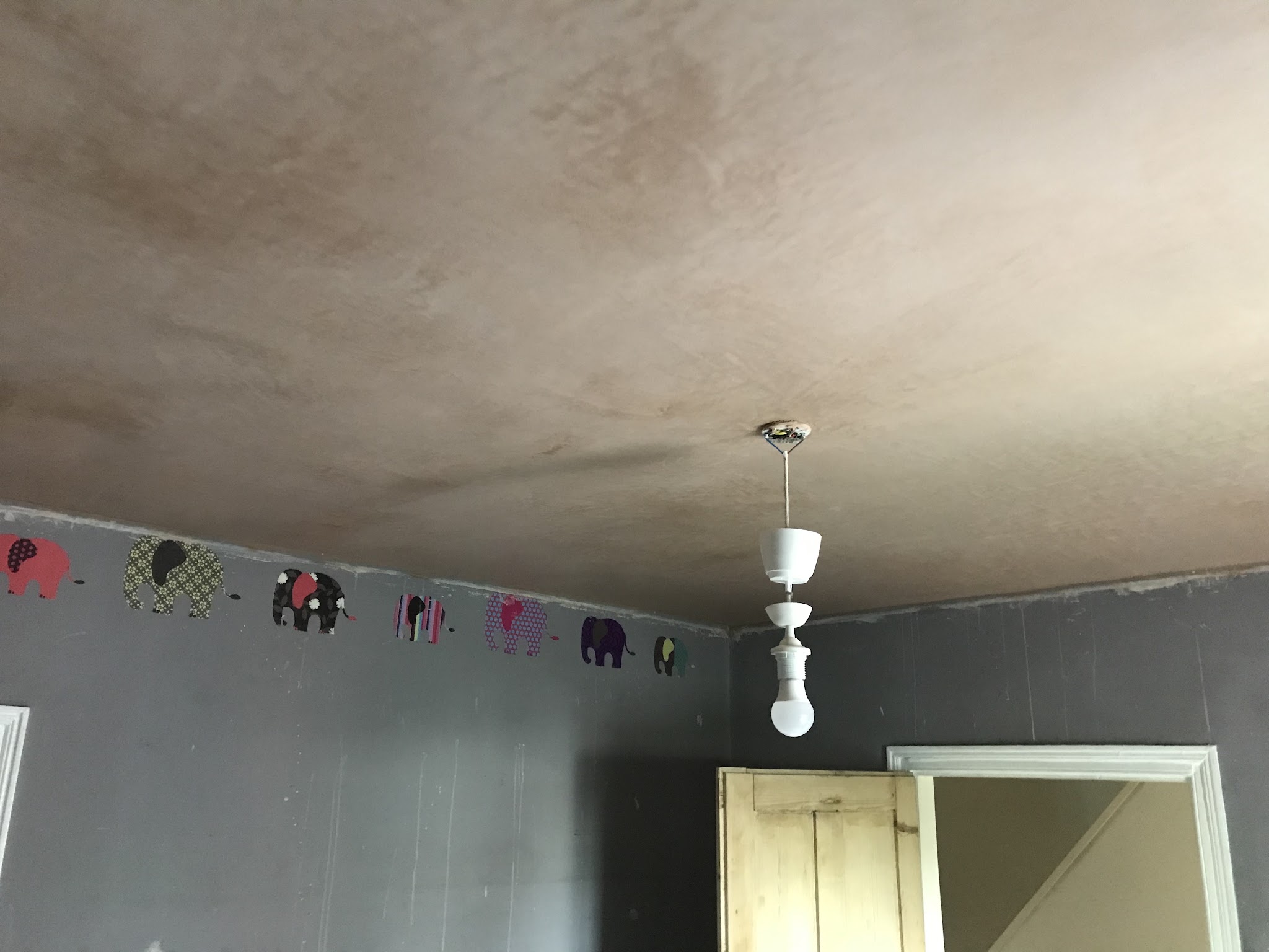 New smooth plastered ceiling over a decorated room